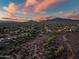 Extensive desert landscape with mountain backdrop highlighting homes with Spanish tile roofs and solar panels at 40123 N Majesty Trl, Anthem, AZ 85086