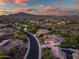 Scenic aerial view of the community featuring desert landscape and mountain views at sunset at 40123 N Majesty Trl, Anthem, AZ 85086