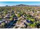 Wide aerial view featuring the home's neighborhood, desert landscape, and mountain backdrop, highlighting location at 40123 N Majesty Trl, Anthem, AZ 85086
