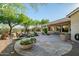 A delightful flagstone patio with a covered seating area and landscaped backyard with a water feature at 40123 N Majesty Trl, Anthem, AZ 85086