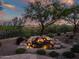 Backyard view of stone water feature with boulder accents, desert landscaping, and wrought iron fence at 40123 N Majesty Trl, Anthem, AZ 85086