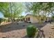 Landscaped backyard with desert trees, rock features and lush plantings, offering a private oasis at 40123 N Majesty Trl, Anthem, AZ 85086