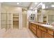 Spacious bathroom featuring dual sinks, granite countertops, walk-in closet, and a glass-enclosed shower at 40123 N Majesty Trl, Anthem, AZ 85086