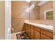 Well-lit bathroom featuring a double sink vanity, warm neutral color palette, and a large mirror at 40123 N Majesty Trl, Anthem, AZ 85086