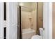 Cozy bathroom featuring a shower over tub, neutral color palette, and tiled walls at 40123 N Majesty Trl, Anthem, AZ 85086