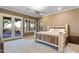 Relaxing bedroom with rustic wood bed, neutral color palette, and lots of natural light at 40123 N Majesty Trl, Anthem, AZ 85086