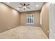 Spacious bedroom featuring neutral carpet, ceiling fan, and window with plantation shutters at 40123 N Majesty Trl, Anthem, AZ 85086