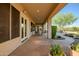 View of the covered patio overlooking the landscaped backyard and water feature at 40123 N Majesty Trl, Anthem, AZ 85086