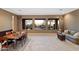 Open dining room with backyard views from three picture windows; includes table and sofa at 40123 N Majesty Trl, Anthem, AZ 85086