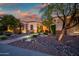 Charming single-story home with stone accents, desert landscaping, and well-lit walkway for curb appeal at 40123 N Majesty Trl, Anthem, AZ 85086