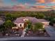 Beautiful desert home at twilight featuring lush landscaping, pavers, uplighting, and stone accents at 40123 N Majesty Trl, Anthem, AZ 85086