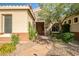 Inviting front entrance with stone accents and beautiful desert landscaping with flowering plants along stone walkway at 40123 N Majesty Trl, Anthem, AZ 85086