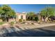 Charming single-story home featuring stone accents, desert landscaping and mature trees in front yard at 40123 N Majesty Trl, Anthem, AZ 85086
