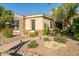 Beautiful single-story home with desert landscaping, stone accents, and mature trees in front yard at 40123 N Majesty Trl, Anthem, AZ 85086