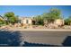Charming single-story home featuring stone accents, desert landscaping and mature trees in front yard at 40123 N Majesty Trl, Anthem, AZ 85086