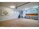 Spacious three car garage with gray cabinets, work bench, and epoxy flooring at 40123 N Majesty Trl, Anthem, AZ 85086