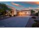 Spacious three-car garage with ample parking space, complemented by desert landscaping and inviting exterior at 40123 N Majesty Trl, Anthem, AZ 85086