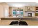 Spacious kitchen featuring granite countertops, a breakfast nook with backyard views, and a cozy fireplace at 40123 N Majesty Trl, Anthem, AZ 85086