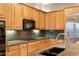 Beautiful kitchen with natural wood cabinets, granite countertops, and modern stainless steel appliances at 40123 N Majesty Trl, Anthem, AZ 85086