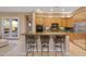 Gourmet kitchen featuring island with bar seating, granite countertops, and stainless steel appliances at 40123 N Majesty Trl, Anthem, AZ 85086