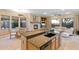 Open floor plan with kitchen, dining, and living areas; fireplace, ceiling fans, and backyard views at 40123 N Majesty Trl, Anthem, AZ 85086
