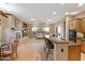 Open floor plan with kitchen island, breakfast area, and living room with fireplace at 40123 N Majesty Trl, Anthem, AZ 85086