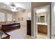 Comfortable bedroom with ceiling fan, ensuite bath, and plantation shutters for a bright, airy feel at 40123 N Majesty Trl, Anthem, AZ 85086