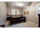 Cozy bedroom featuring neutral walls, carpeted floor, plantation shutters, and decorative bedside lamps at 40123 N Majesty Trl, Anthem, AZ 85086