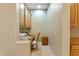 A compact office space with built-in desk, cabinets, drawers, and neutral decor at 40123 N Majesty Trl, Anthem, AZ 85086
