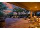 Inviting covered patio with stone flooring, water feature, and outdoor dining set for relaxing or entertaining at 40123 N Majesty Trl, Anthem, AZ 85086
