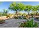 A gorgeous water feature in a landscaped yard, featuring flowers in the foreground at 40123 N Majesty Trl, Anthem, AZ 85086
