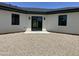 Gravel backyard with sliding doors to the home's interior at 4079 E Roosevelt St, Apache Junction, AZ 85119