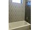 Shower and tub area with decorative tiling at 4079 E Roosevelt St, Apache Junction, AZ 85119