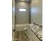 Modern bathroom showcasing a tiled shower, granite countertop, and a wooden-look floor at 4079 E Roosevelt St, Apache Junction, AZ 85119