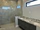 Bathroom featuring walk-in shower with gray tile and double vanity with granite countertop at 4079 E Roosevelt St, Apache Junction, AZ 85119