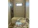 Bathroom with shower-tub combo, geometric tile wall, granite countertop, and chrome fixtures at 4079 E Roosevelt St, Apache Junction, AZ 85119