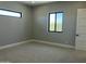 Neutral bedroom featuring carpet flooring, modern windows, and a white door at 4079 E Roosevelt St, Apache Junction, AZ 85119