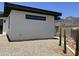 View of the side of the home featuring stucco wall, flat roof and desert landscaping at 4079 E Roosevelt St, Apache Junction, AZ 85119