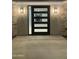 Facade featuring modern lighting, stone and a black, multi-lite front door at 4079 E Roosevelt St, Apache Junction, AZ 85119