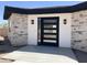 Close up of front door with black trim and stone accents at 4079 E Roosevelt St, Apache Junction, AZ 85119