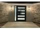 Modern front door with black frame and multiple lites featuring stone and modern lighting at 4079 E Roosevelt St, Apache Junction, AZ 85119