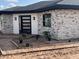 Newly constructed home with stone accents and a modern, dark-trimmed glass front door at 4079 E Roosevelt St, Apache Junction, AZ 85119