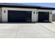 Spacious two car garage with modern black garage doors and concrete driveway at 4079 E Roosevelt St, Apache Junction, AZ 85119