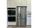 Modern kitchen featuring stainless steel appliances, including a double oven and a refrigerator with built-in water dispenser at 4079 E Roosevelt St, Apache Junction, AZ 85119