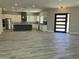 Spacious eat-in kitchen featuring wood floors, granite counters, stainless appliances, and pendant lighting at 4079 E Roosevelt St, Apache Junction, AZ 85119
