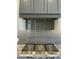 The kitchen boasts gray cabinets, a stainless steel gas range, granite countertops, and a decorative gray tile backsplash at 4079 E Roosevelt St, Apache Junction, AZ 85119