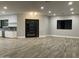 Spacious living room adjacent to the kitchen with modern black-framed windows and wide plank flooring at 4079 E Roosevelt St, Apache Junction, AZ 85119