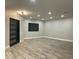 Open living room with modern lighting, wood floors, and black framed window at 4079 E Roosevelt St, Apache Junction, AZ 85119