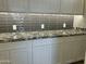 Bright butler's pantry with white cabinets, gray backsplash, granite countertops, and under-cabinet lighting at 4079 E Roosevelt St, Apache Junction, AZ 85119
