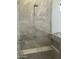 Stylish shower featuring marble-like tile, rain shower, handheld sprayer, bench and built-in niche at 4079 E Roosevelt St, Apache Junction, AZ 85119
